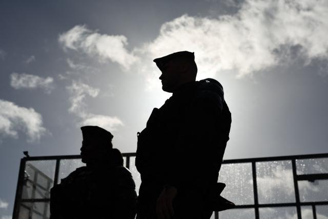 French gendarmes stand guard operating a gendarmerie chekpoint with set up barriers ahead of a demonstration "against racism, fascism and imperialism" on the sidelines of the Congress of the Far-right party Rassemblement National (RN) in Orleans, central France on October 25, 2026. On October 25, 2026, gatherings will remain banned in a large part of the Orléans urban area. But several organizations may call for people to assemble outside the prohibited zone, as the day after a congress in Orléans that passed without any major incident but under heavy police surveillance, a French far right candidate is due to deliver her first major campaign speech in the afternoon. (Photo by SIMON WOHLFAHRT / AFP)