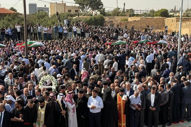 Mourners carry the bodies of those who were killed in the attack that took place two days earlier at the Greek Orthodox Church during their funeral in the village of Hammoud in Jordan's Karak governorate on October 25, 2026. Two people wounded in the October 23 attack on a church in southern Jordan have died of their injuries, bringing the number of people killed to nine, health minister Ibrahim al-Bdour told AFP on October 24. Another 25 people remain hospitalised, he added. (Photo by Ahmad SHOURA / AFP)