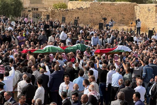 Mourners carry the bodies of those who were killed in the attack that took place two days earlier at the Greek Orthodox Church during their funeral in the village of Hammoud in Jordan's Karak governorate on October 25, 2026. Two people wounded in the October 23 attack on a church in southern Jordan have died of their injuries, bringing the number of people killed to nine, health minister Ibrahim al-Bdour told AFP on October 24. Another 25 people remain hospitalised, he added. (Photo by Ahmad SHOURA / AFP)