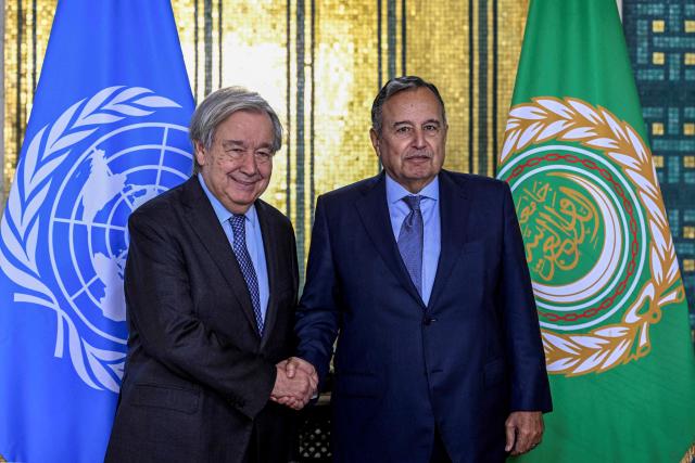 UN Secretary-General Antonio Guterres (L) shakes hands with Arab League Secretary-General Nabil Fahmy following their meeting at the Arab League's headquarters in Cairo on October 25, 2026. (Photo by Khaled DESOUKI / AFP)
