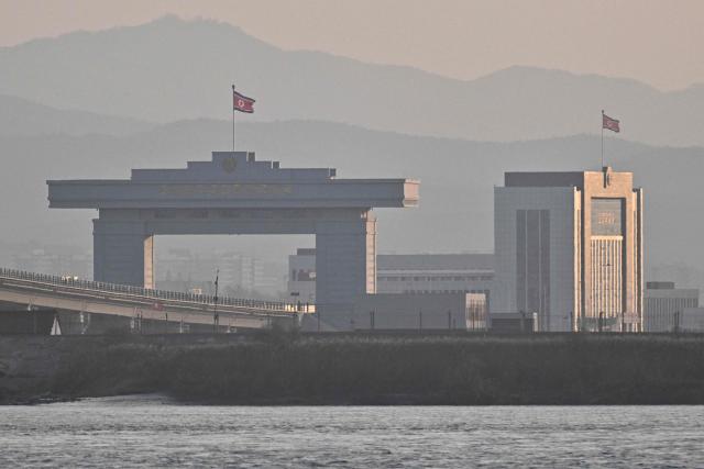 A general view shows the North Korean gate (L) of a new cross-border bridge linking China and North Korea, as seen from Dandong, in northeastern China's Liaoning province, on October 25, 2026. North Korean leader Kim Jong Un returned home October 24 after a day-long trip to the Chinese border city of Dandong, Beijing's state media reported, though the purpose of the unannounced visit was not immediately clear. (Photo by Pedro PARDO / AFP)