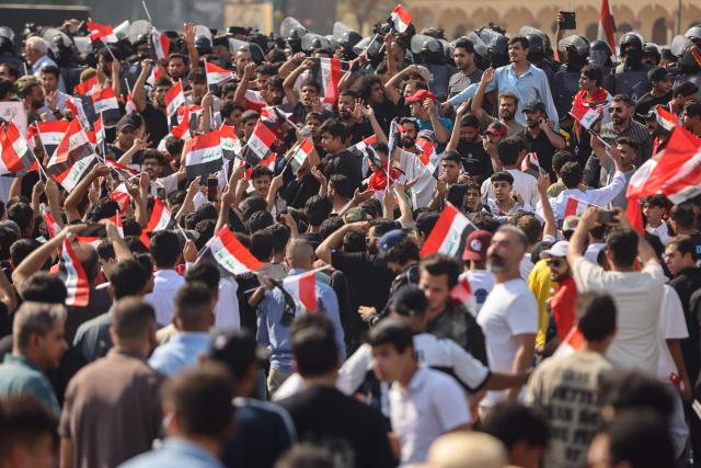 Protesters wave flags of Iraq as they gather in Baghdad's Tahrir Square on October 25, 2026 to mark the 7th anniversary of the 2019 Iraqi anti-government demonstrations. (Photo by AHMAD AL-RUBAYE / AFP)