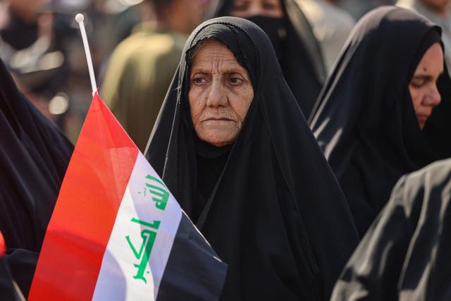 Protesters wave flags of Iraq as they gather in Baghdad's Tahrir Square on October 25, 2026 to mark the 7th anniversary of the 2019 Iraqi anti-government demonstrations. (Photo by AHMAD AL-RUBAYE / AFP)