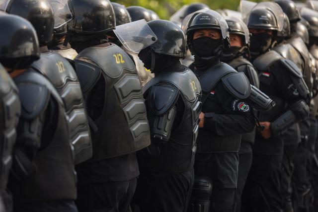 Riot police watch protesters as they gather in Baghdad's Tahrir Square on October 25, 2026 to mark the 7th anniversary of the 2019 Iraqi anti-government demonstrations. (Photo by AHMAD AL-RUBAYE / AFP)