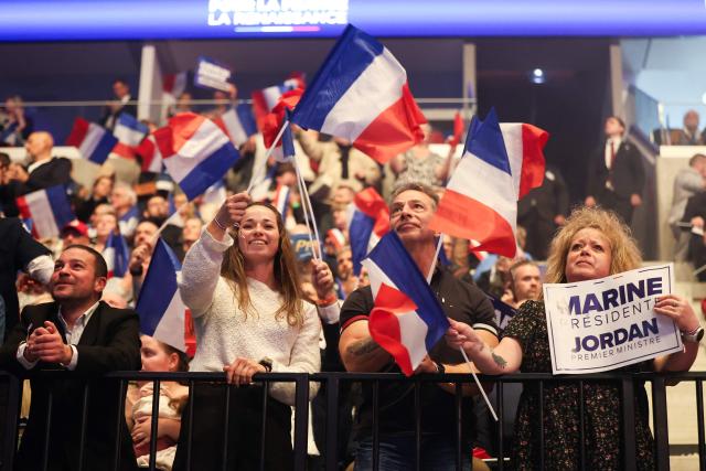 Supporters wave French flags during Launch rally for Marine Le Pen’s presidential campaign as part of the Congress of the Far-right party Rassemblement National (RN) in Orleans, central France on October 25, 2026. (Photo by ROMAIN PERROCHEAU / AFP)