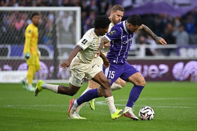 Toulouse's Norwegian midfielder #15 Aron Donnum fights for the ball with Troyes' Togolese midfielder #29 Dermane Karim (L) during the French L1 football match between Toulouse FC and ESTAC Troyes at the stadium TFC in Toulouse, south-western France on October 25, 2026. (Photo by Matthieu RONDEL / AFP)