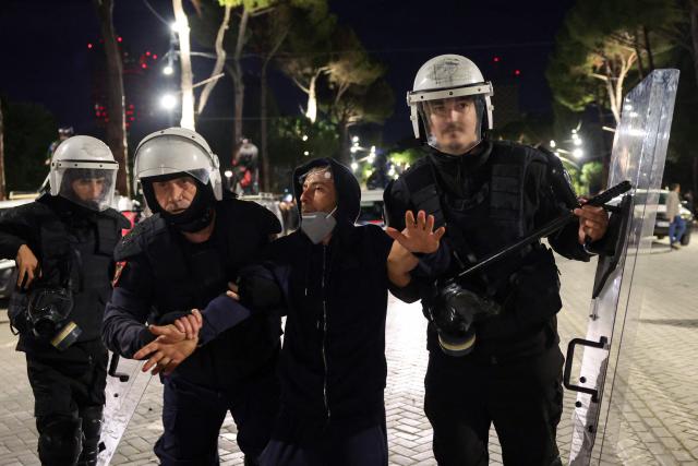 Riot police officers detain a protester during an anti-government demonstration - called by the student-led protest movement to denounce poor study conditions and corruption and to demand prime minister's resignation, in central Tirana on October 25, 2026. (Photo by Adnan Beci / AFP)