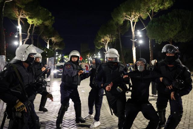 Riot police officers detain protesters during an anti-government demonstration - called by the student-led protest movement to denounce poor study conditions and corruption and to demand prime minister's resignation, in central Tirana on October 25, 2026. (Photo by Adnan Beci / AFP)