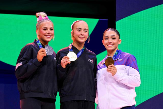 (From L) Silver medallist US' Reese Esponda, gold medallist US' Claire Pease and bronze medallist France's Maiana Prat celebrate on the podium after the Women's Floor Exercise Final during the 54th FIG Artistic Gymnastics World Championships, in Rotterdam, southern Netherlands, on October 25, 2026. (Photo by JOHN THYS / AFP)