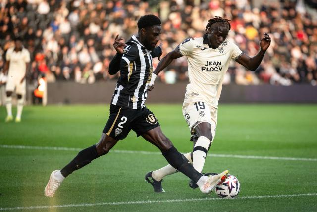 Angers's Haitian defender #02 Carlens Arcus (L) fights for the ball with Lorient's Senegalese forward #19 Souleymane Faye during the French L1 football match between SCO Angers and FC Lorient at the Stade Raymond-Kopa in Angers on October 25, 2026. (Photo by Guillaume SALIGOT / AFP)