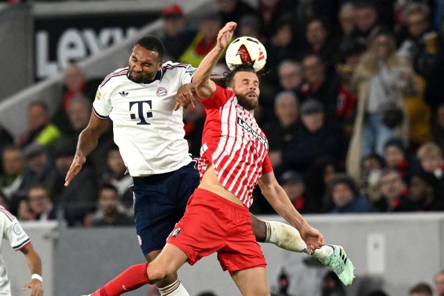 Bayern Munich's German defender #04 Jonathan Tah (C) and Freiburg's German forward #09 Lucas Hoeler (R) vie for a header during the German first division Bundesliga football match between SC Freiburg and FC Bayern Munich in Freiburg, south-western Germany, on October 25, 2026. (Photo by THOMAS KIENZLE / AFP) / DFL REGULATIONS PROHIBIT ANY USE OF PHOTOGRAPHS AS IMAGE SEQUENCES AND/OR QUASI-VIDEO