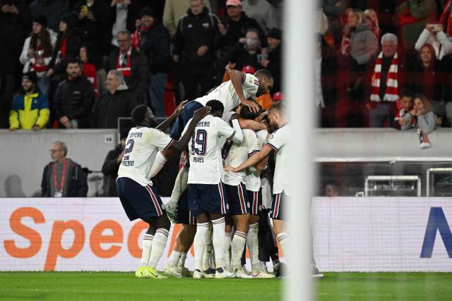 Team mates celebrate Bayern Munich's French midfielder #17 Michael Olise (hidden) after he scored the 1:3 goal during the German first division Bundesliga football match between SC Freiburg and FC Bayern Munich in Freiburg, south-western Germany, on October 25, 2026. (Photo by THOMAS KIENZLE / AFP) / DFL REGULATIONS PROHIBIT ANY USE OF PHOTOGRAPHS AS IMAGE SEQUENCES AND/OR QUASI-VIDEO
