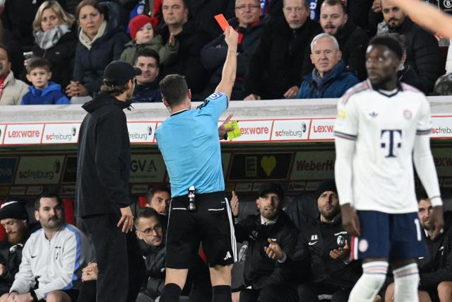 German referee Felix Zwayer shows a red card to one member of the bench from SC Freiburg team during the German first division Bundesliga football match between SC Freiburg and FC Bayern Munich in Freiburg, south-western Germany, on October 25, 2026. (Photo by THOMAS KIENZLE / AFP) / DFL REGULATIONS PROHIBIT ANY USE OF PHOTOGRAPHS AS IMAGE SEQUENCES AND/OR QUASI-VIDEO