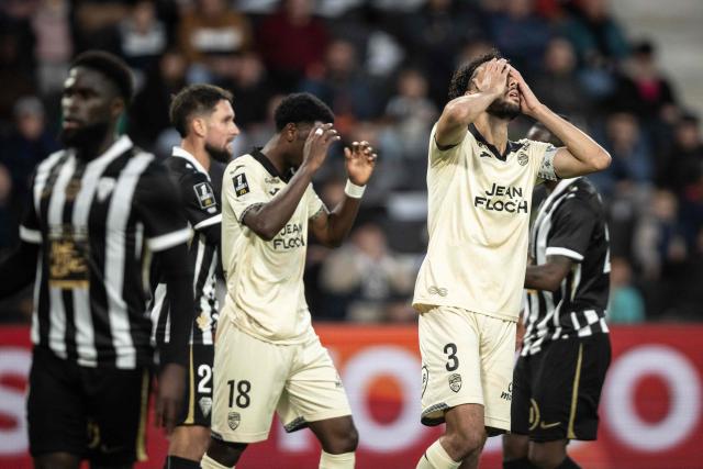 Lorient's French forward #18 Ibrahima Balde and Lorient's Tunisian defender #03 Montassar Talbi react during the French L1 football match between SCO Angers and FC Lorient at the Stade Raymond-Kopa in Angers on October 25, 2026. (Photo by Guillaume SALIGOT / AFP)