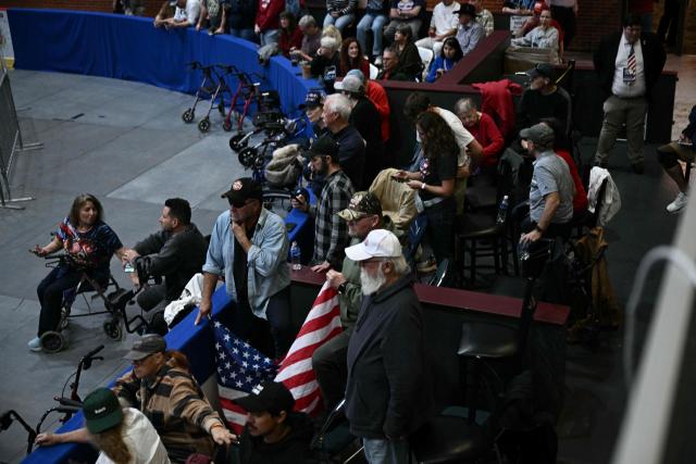 Attendees wait for US President Donald Trump to speak at a campaign rally at the McMorran Place Sports & Entertainment Center in Port Huron, Michigan, on October 25, 2026. (Photo by Brendan SMIALOWSKI / AFP)