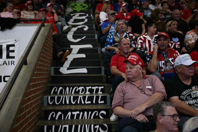 Attendees wait for US President Donald Trump to speak at a campaign rally at the McMorran Place Sports & Entertainment Center in Port Huron, Michigan, on October 25, 2026. (Photo by Brendan SMIALOWSKI / AFP)