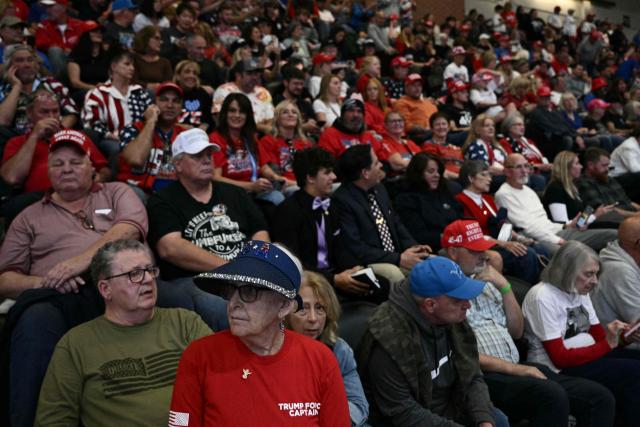 Attendees wait for US President Donald Trump to speak at a campaign rally at the McMorran Place Sports & Entertainment Center in Port Huron, Michigan, on October 25, 2026. (Photo by Brendan SMIALOWSKI / AFP)