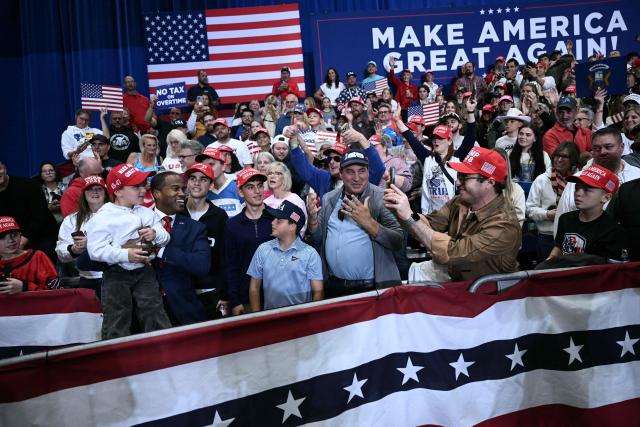 Attendees wait for US President Donald Trump to speak at a campaign rally at the McMorran Place Sports & Entertainment Center in Port Huron, Michigan, on October 25, 2026. (Photo by Brendan SMIALOWSKI / AFP)