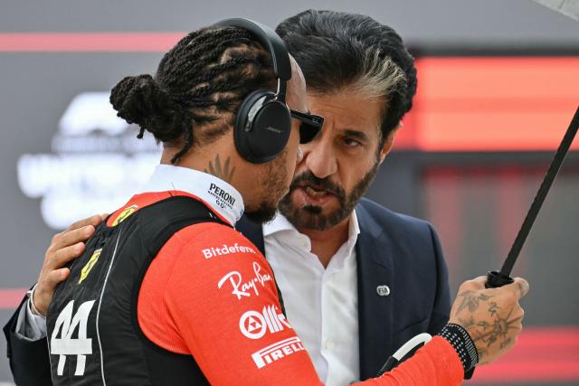 (L/R) Ferrari's British driver Lewis Hamilton speaks with FIA President Mohammed Ben Sulayem before the start of the United States Formula One Grand Prix at the Circuit of the Americas in Austin, Texas, on October 25, 2026. (Photo by ANGELA WEISS / AFP)