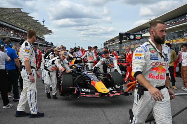 Red Bull Racing team members help Red Bull Racing's Dutch driver Max Verstappen make his way to the starting grid before the start of the United States Formula One Grand Prix at the Circuit of the Americas in Austin, Texas, on October 25, 2026. (Photo by ANGELA WEISS / AFP)