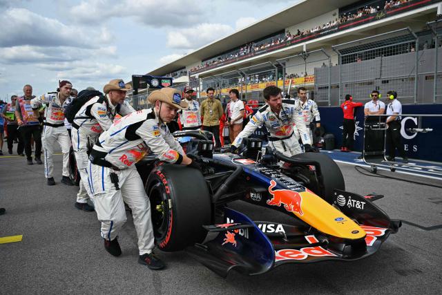 Red Bull Racing team members help Red Bull Racing's Dutch driver Max Verstappen make his way to the starting grid before the start of the United States Formula One Grand Prix at the Circuit of the Americas in Austin, Texas, on October 25, 2026. (Photo by ANGELA WEISS / AFP)