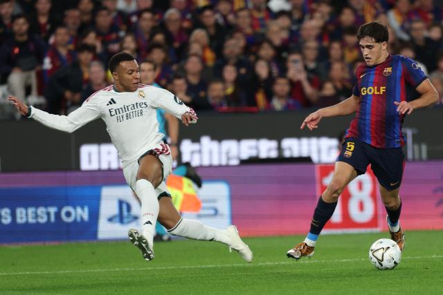 Real Madrid's French forward #10 Kylian Mbappe (L) is challenged by Barcelona's Spanish defender #05 Pau Cubarsi during the Spanish league football match between FC Barcelona and Real Madrid CF at Camp Nou Stadium in Barcelona on October 25, 2026. (Photo by Lluis GENE / AFP)