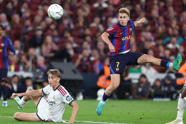 Barcelona's Spanish midfielder #07 Fermin Lopez (R) shoots past Real Madrid's Spanish defender #04 Dean Huijsen during the Spanish league football match between FC Barcelona and Real Madrid CF at Camp Nou Stadium in Barcelona on October 25, 2026. (Photo by Josep LAGO / AFP)