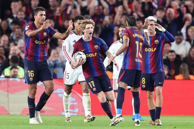 Barcelona's Brazilian forward #11 Raphinha celebrates scoring his team's first goal with teammates during the Spanish league football match between FC Barcelona and Real Madrid CF at Camp Nou Stadium in Barcelona on October 25, 2026. (Photo by Josep LAGO / AFP)