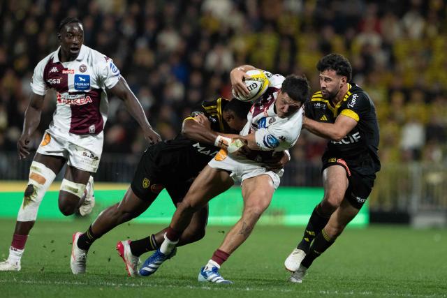 Bordeaux-Bègles' French centre Nicolas Depoortere attempts to break away next to La Rochelle's French fly-half Antoine Hastoy (R) during the French Top14 rugby union match between Stade Rochelais (La Rochelle) and Union Bordeaux Bègles (UBB) at the Marcel-Deflandre Stadium in La Rochelle, western France, on October 25, 2026. (Photo by XAVIER LEOTY / AFP)