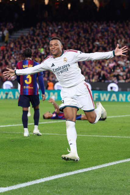 Real Madrid's French forward #10 Kylian Mbappe celebrates scoring his team's second goal during the Spanish league football match between FC Barcelona and Real Madrid CF at Camp Nou Stadium in Barcelona on October 25, 2026. (Photo by Josep LAGO / AFP)