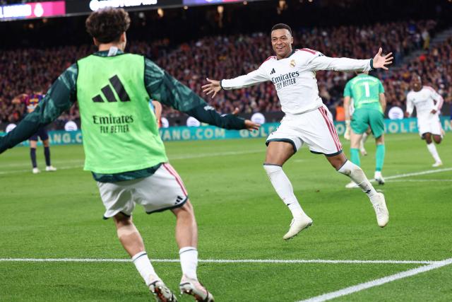 Real Madrid's French forward #10 Kylian Mbappe celebrates scoring his team's second goal during the Spanish league football match between FC Barcelona and Real Madrid CF at Camp Nou Stadium in Barcelona on October 25, 2026. (Photo by Josep LAGO / AFP)