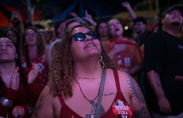 A supporter of Brazil's President and presidential candidate Luiz Inacio Lula da Silva waits for the first results in downtown Rio de Janeiro, Brazil on October 25, 2026. Brazil's Supreme Court extended voting time for two hours on Sunday, generating chaos in a knife-edge election race Sunday between right-wing senator Flavio Bolsonaro and leftist President Luiz Inacio Lula da Silva. (Photo by TERCIO TEIXEIRA / AFP)