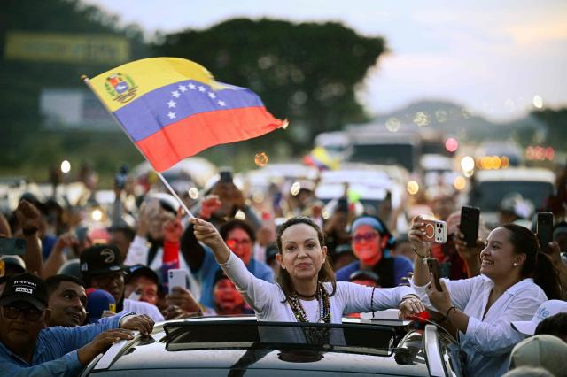 Venezuelan opposition leader and Nobel Peace Prize laureate Maria Corina Machado greets supporters after her arrival in Caracas on October 25, 2026. Machado returned to her home country on October 25, 2026, after almost a year in exile, greeting ecstatic supporters at a church in the city of Barquisimeto. (Photo by Federico PARRA / AFP)