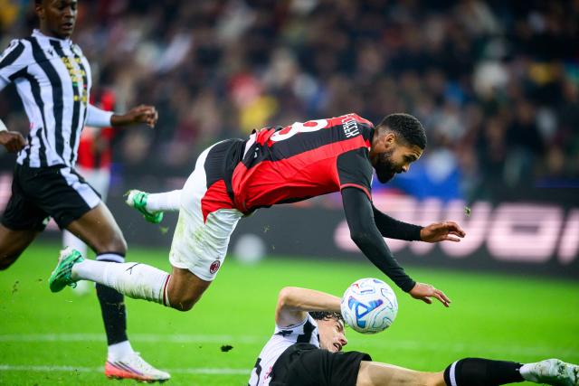 Udinese's Italian-German defender #16 Matteo Palma tackles AC Milan's English midfielder #08 Ruben Loftus-Cheek (up) during the Italian Serie A football match between Udinese and Milan at the Stadio Friuli in Udine on October 25, 2026. (Photo by Jure Makovec / AFP)