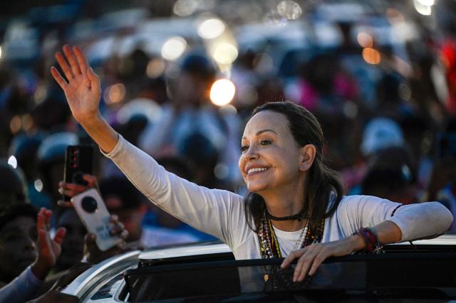 Venezuelan opposition leader and Nobel Peace Prize laureate Maria Corina Machado greets supporters after her arrival in Caracas on October 25, 2026. Machado returned to her home country on October 25, 2026, after almost a year in exile, greeting ecstatic supporters at a church in the city of Barquisimeto. (Photo by Federico PARRA / AFP)