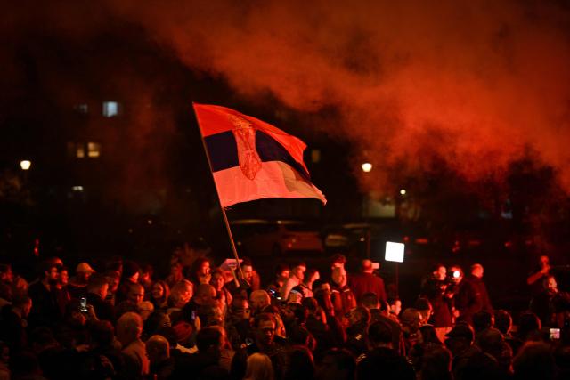 Supporters of the Students’ List wave the Serbian flag as they celebrate their victory in the Serbian parliamentary elections, in downtown Belgrade on October 25, 2026. Voters cast ballots in record numbers on October 25, 2026, with the country recording its highest parliamentary election turnout in more than three decades. Celebrations erupted on the streets of the capital; passing cars honked their horns as crowds began to party at the news that Serbia's ruling party had lost parliamentary snap elections. (Photo by ANDREJ ISAKOVIC / AFP)