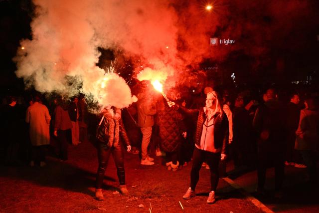Supporters of the Students’ List celebrate their victory in the Serbian parliamentary elections, in downtown Belgrade on October 25, 2026. Voters cast ballots in record numbers on October 25, 2026, with the country recording its highest parliamentary election turnout in more than three decades. Celebrations erupted on the streets of the capital; passing cars honked their horns as crowds began to party at the news that Serbia's ruling party had lost parliamentary snap elections. (Photo by Andrej ISAKOVIC / AFP)