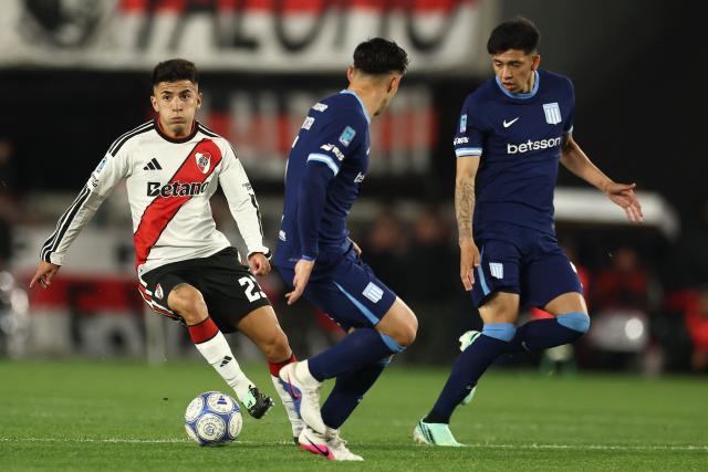River Plate's midfielder #23 Thiago Almada, Racing's midfielders #05 Matias Kranevitter and #46 Alejandro Tello fight for the ball during the Argentine Professional League 2026 Clausura tournament football match between River Plate and Racing at Monumental stadium in Buenos Aires on October 25, 2026. (Photo by Alejandro PAGNI / AFP)