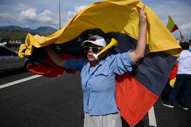 A supporters waits for Venezuelan opposition leader and Nobel Peace Prize laureate Maria Corina Machado to arrive in Caracas on October 25, 2026. Machado returned to her home country on October 25, 2026, after almost a year in exile, greeting ecstatic supporters at a church in the city of Barquisimeto. (Photo by Federico PARRA / AFP)