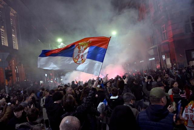 Supporters of the Students’ List gather to celebrate their victory in the Serbian parliamentary elections, in downtown Belgrade on October 25, 2026. Voters cast ballots in record numbers on October 25, 2026, with the country recording its highest parliamentary election turnout in more than three decades. Celebrations erupted on the streets of the capital; passing cars honked their horns as crowds began to party at the news that Serbia's ruling party had lost parliamentary snap elections. (Photo by MARKO LJUTICA / AFP)