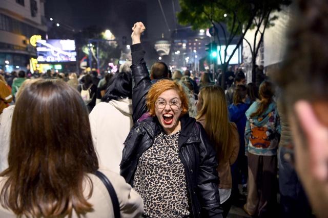 Supporters of the Students’ List celebrate their victory in the Serbian parliamentary elections, in downtown Belgrade on October 25, 2026. Voters cast ballots in record numbers on October 25, 2026, with the country recording its highest parliamentary election turnout in more than three decades. Celebrations erupted on the streets of the capital; passing cars honked their horns as crowds began to party at the news that Serbia's ruling party had lost parliamentary snap elections. (Photo by MARKO LJUTICA / AFP)