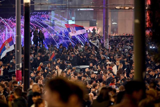 Supporters of the Students’ List celebrate their victory in the Serbian parliamentary elections, in downtown Belgrade on October 25, 2026. Voters cast ballots in record numbers on October 25, 2026, with the country recording its highest parliamentary election turnout in more than three decades. Celebrations erupted on the streets of the capital; passing cars honked their horns as crowds began to party at the news that Serbia's ruling party had lost parliamentary snap elections. (Photo by MARKO LJUTICA / AFP)