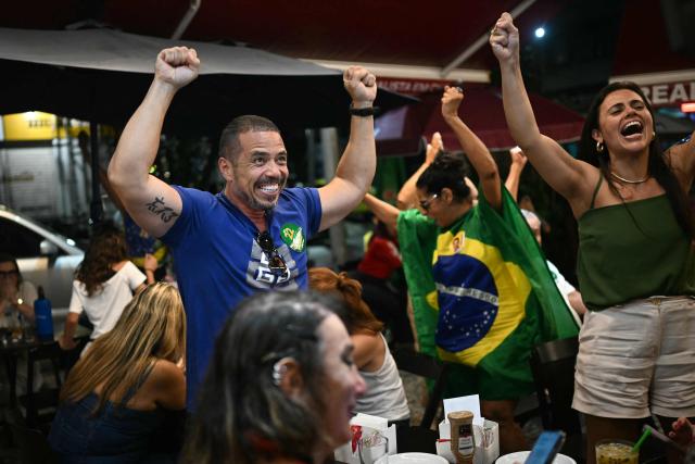 Supporters of Brazil's right-wing Senator and Liberal Party (PL) presidential candidate Flavio Bolsonaro react in Copacabana, Rio de janeiro , Brazil, on October 25, 2026, the day of the presidential runoff election. Brazilians head to the polls for a runoff between President Luiz Inacio Lula da Silva and right-wing senator Flavio Bolsonaro that will determine whether Brazil remains one of the few leftist nations in the region or joins a regional swing to the right championed by US President Donald Trump, a Bolsonaro ally. (Photo by MAURO PIMENTEL / AFP)