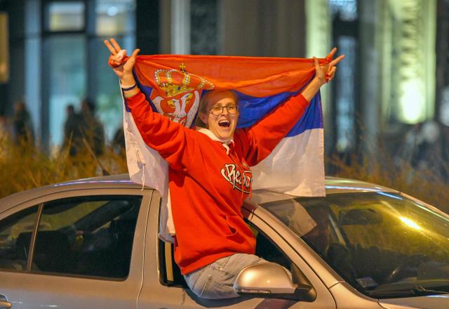 Citizens of Northern-Serbian city of Novi Sad celebrate in the streets after students movement declared victory of their candidates list at snap Parliamentary elections, on October 25, 2026. Voters cast ballots in record numbers on October 25, 2026, with the country recording its highest parliamentary election turnout in more than three decades. Celebrations erupted on the streets of the capital; passing cars honked their horns as crowds began to party at the news that Serbia's ruling party had lost parliamentary snap elections. (Photo by NENAD MIHAJLOVIC / AFP)