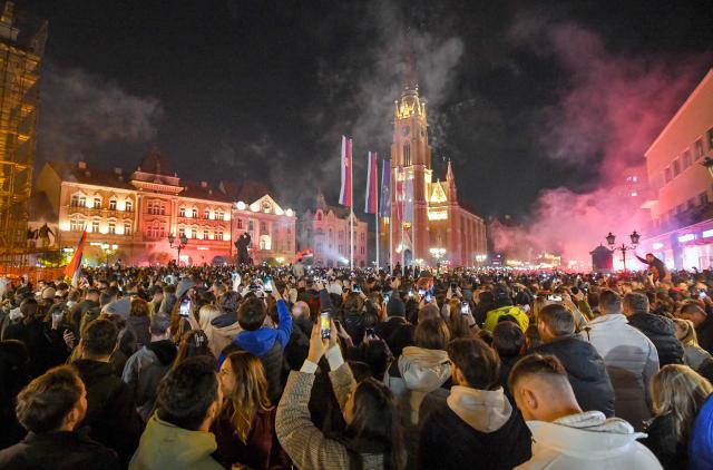 Citizens of Northern-Serbian city of Novi Sad celebrate in the streets after students movement declared victory of their candidates list at snap Parliamentary elections, on October 25, 2026. Voters cast ballots in record numbers on October 25, 2026, with the country recording its highest parliamentary election turnout in more than three decades. Celebrations erupted on the streets of the capital; passing cars honked their horns as crowds began to party at the news that Serbia's ruling party had lost parliamentary snap elections. (Photo by NENAD MIHAJLOVIC / AFP)
