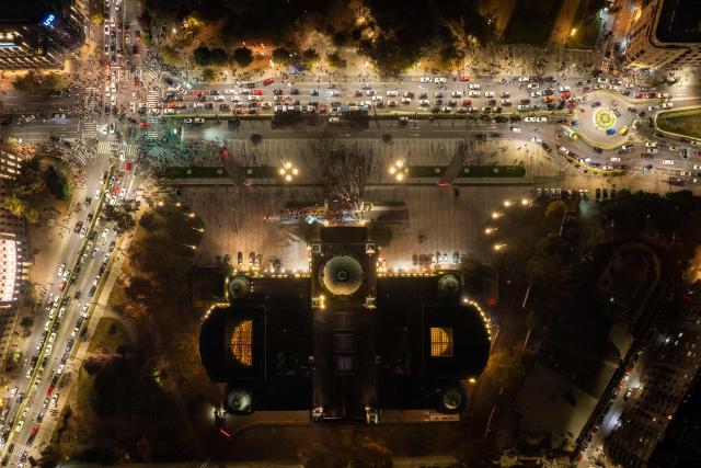 An aerial view shows supporters of the Students List gather outside The House of the National Assembly as they celebrate their victory in the Serbian parliamentary elections, in Belgrade on October 25, 2026. Voters cast ballots in record numbers on October 25, 2026, with the country recording its highest parliamentary election turnout in more than three decades. Celebrations erupted on the streets of the capital; passing cars honked their horns as crowds began to party at the news that Serbia's ruling party had lost parliamentary snap elections. (Photo by DJORDJE KOSTIC / AFP)