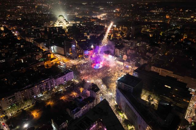 An aerial photo shows supporters of the Students’ List gather at the Slavija square as they celebrate their victory in the Serbian parliamentary elections, in Belgrade on October 25, 2026. Voters cast ballots in record numbers on October 25, 2026, with the country recording its highest parliamentary election turnout in more than three decades. Celebrations erupted on the streets of the capital; passing cars honked their horns as crowds began to party at the news that Serbia's ruling party had lost parliamentary snap elections. (Photo by DJORDJE KOSTIC / AFP)