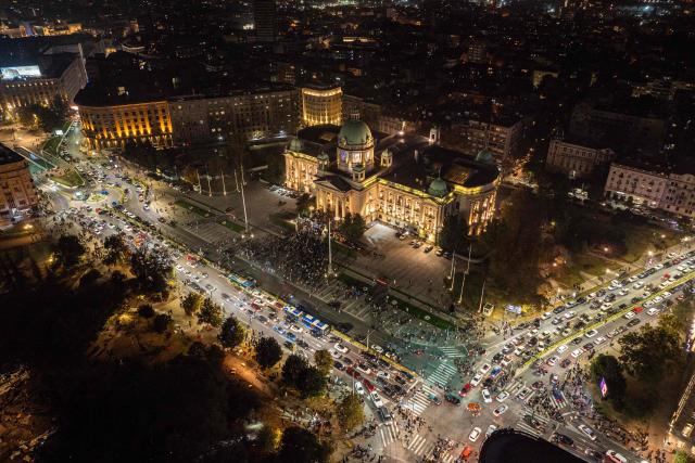 An aerial view shows supporters of the Students List gather outside The House of the National Assembly as they celebrate their victory in the Serbian parliamentary elections, in Belgrade on October 25, 2026. Voters cast ballots in record numbers on October 25, 2026, with the country recording its highest parliamentary election turnout in more than three decades. Celebrations erupted on the streets of the capital; passing cars honked their horns as crowds began to party at the news that Serbia's ruling party had lost parliamentary snap elections. (Photo by DJORDJE KOSTIC / AFP)