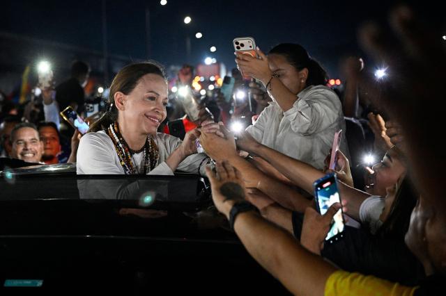 Venezuelan opposition leader and Nobel Peace Prize laureate Maria Corina Machado greets supporters after her arrival in Caracas on October 25, 2026. Machado returned to her home country on October 25, 2026, after almost a year in exile, greeting ecstatic supporters at a church in the city of Barquisimeto. (Photo by Federico PARRA / AFP)