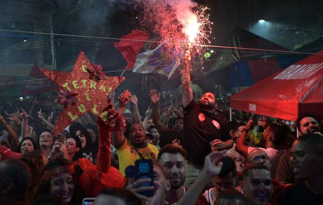 Supporters of Brazil's President and presidential candidate Luiz Inacio Lula da Silva celebrate after the first results of the presidential runoff election in Rio de Janeiro, Brazil on October 25, 2026. Lula holds slight lead over Bolsonaro with 75% of Brazil votes counted. (Photo by TERCIO TEIXEIRA / AFP)